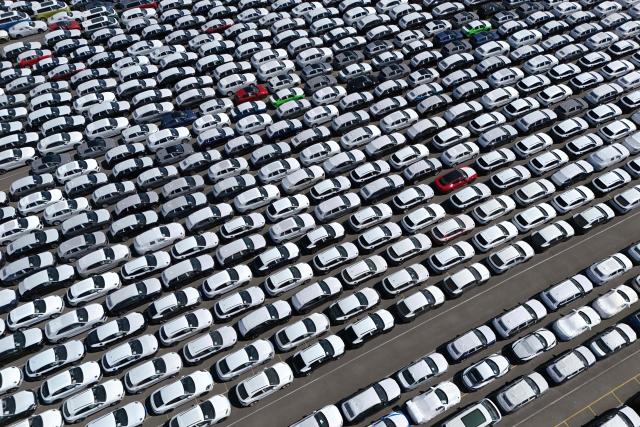 (FILES) An aerial view shows new cars of German car maker Volkswagen group ready for shipping next to the Volkswagen plant in Emden, northwestern Germany on May 20, 2025. India and the European Union announced on January 27, 2026 the "mother of all deals", a huge trade pact to create a market of two billion people, reached after two decades of negotiations. (Photo by Ina FASSBENDER / AFP)