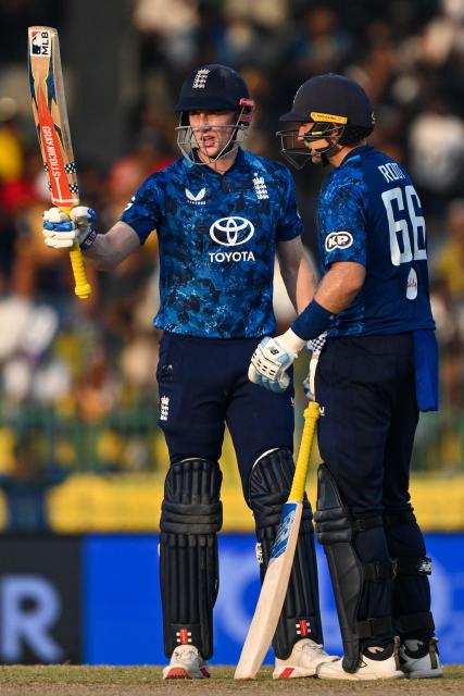 England's captain Harry Brook (L) celebrates after scoring a half-century (50 runs) with Joe Root (R) during the third one-day international (ODI) cricket match between Sri Lanka and England at the R. Premadasa International Cricket Stadium in Colombo on January 27, 2026. (Photo by Ishara S. KODIKARA / AFP)