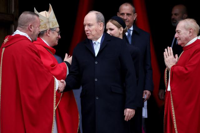 Prince Albert II of Monaco (C) and Princess Charlene of Monaco (C-R) leave the cathedral after taking part in the traditional festivities of Sainte Devote in the Principalty of Monaco on January 27, 2026. (Photo by Valery HACHE / AFP) / NO TABLOIDS WEB & PRINT, NO DAILY MAIL, NO DAILY MAIL GROUP, NO VOICI, NO CLOSER
