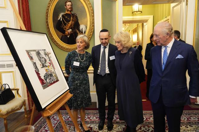Britain's King Charles III (R) and Queen Camilla (2nd R) view an Anne Frank portrait by Peter Sacks, with Nicola Cobbold (L) and Dan Green (2nd L) from the Anne Frank Trust, during a reception for survivors of the Holocaust and their families at Buckingham Palace in central London on January 27, 2026, held to mark Holocaust Memorial Day. Holocaust Memorial Day takes place every year on January 27, the anniversary of the liberation of the Auschwitz-Birkenau. The day commemorates the six million Jewish people murdered during the Holocaust, and the millions more murdered under Nazi persecution. (Photo by Aaron Chown / POOL / AFP)