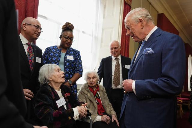 Britain's King Charles III (R) speaks with Holocaust survivor Kitty Hart-Moxon (bottom L) during a reception for survivors of the Holocaust and their families at Buckingham Palace in central London on January 27, 2026, held to mark Holocaust Memorial Day. Holocaust Memorial Day takes place every year on January 27, the anniversary of the liberation of the Auschwitz-Birkenau. The day commemorates the six million Jewish people murdered during the Holocaust, and the millions more murdered under Nazi persecution. (Photo by Aaron Chown / POOL / AFP)