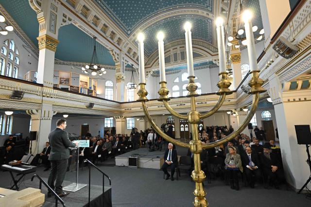 Gergely Gulyas (L), Minister of the Hungarian Prime Minister's Office, delivers a speech during a commemoration of the International Holocaust Remembrance Day at the synagogye of the Holocaust Memorial Center in Budapest, Hungary, on January 27, 2026. The choice of January 27 for the annual commemoration aligns with the liberation of the Auschwitz concentration camp by the Red Army in 1945. (Photo by Attila KISBENEDEK / AFP)