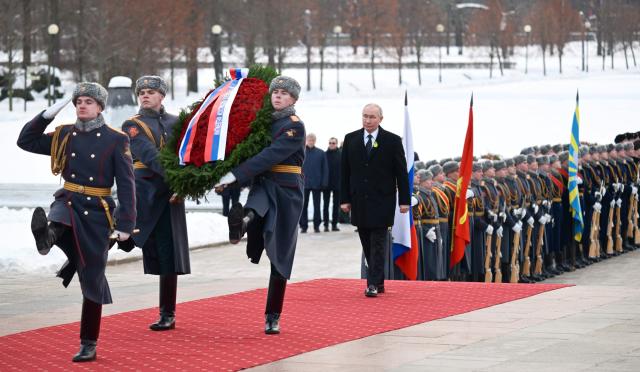 In this pool photograph distributed by the Russian state agency Sputnik, Russia's President Vladimir Putin attends a wreath-laying ceremony at the monument 'Motherland' at the Piskaryovskoye Memorial Cemetery in Saint Petersburg on January 27, 2026, marking the 82nd anniversary of the liberation of Leningrad from Nazi blockade in World War Two. (Photo by Alexei Danichev / POOL / AFP)