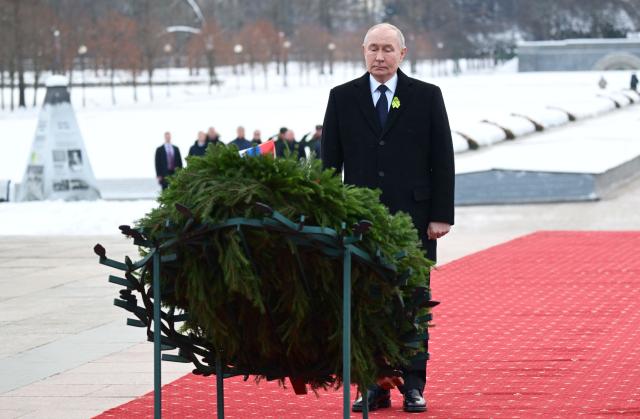 In this pool photograph distributed by the Russian state agency Sputnik, Russia's President Vladimir Putin attends a wreath-laying ceremony at the monument 'Motherland' at the Piskaryovskoye Memorial Cemetery in Saint Petersburg on January 27, 2026, marking the 82nd anniversary of the liberation of Leningrad from Nazi blockade in World War Two. (Photo by Alexei Danichev / POOL / AFP)