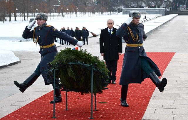 In this pool photograph distributed by the Russian state agency Sputnik, Russia's President Vladimir Putin attends a wreath-laying ceremony at the monument 'Motherland' at the Piskaryovskoye Memorial Cemetery in Saint Petersburg on January 27, 2026, marking the 82nd anniversary of the liberation of Leningrad from Nazi blockade in World War Two. (Photo by Alexei Danichev / POOL / AFP)