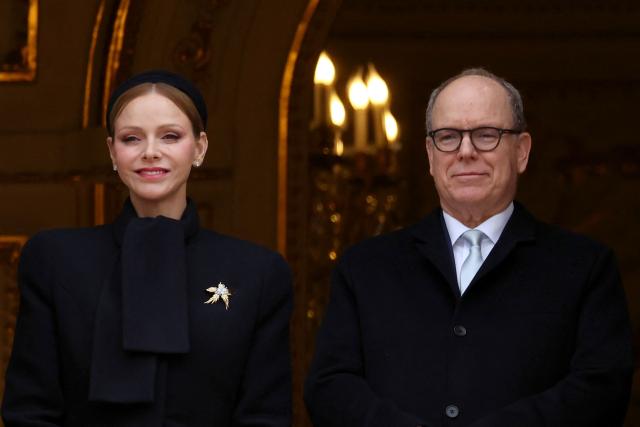 Prince Albert II of Monaco (R) and Princess Charlene of Monaco appear on the balcony during the traditional festivities of Sainte Devote in the Principalty of Monaco on January 27, 2026. (Photo by Valery HACHE / AFP) / NO TABLOIDS WEB & PRINT, NO DAILY MAIL, NO DAILY MAIL GROUP, NO VOICI, NO CLOSER