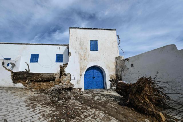A photograph shows the damage in the hills of Sidi Bouzid on January 27, 2026, after the region was hit by Storm Harry. Authorities have ordered the evacuation of several homes at risk of collapsing in the tourist village. (Photo by FETHI BELAID / AFP)