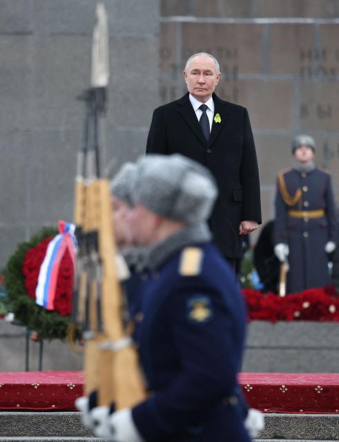 In this pool photograph distributed by the Russian state agency Sputnik, Russia's President Vladimir Putin attends a wreath-laying ceremony at the monument 'Motherland' at the Piskaryovskoye Memorial Cemetery in Saint Petersburg on January 27, 2026, marking the 82nd anniversary of the liberation of Leningrad from Nazi blockade in World War Two. (Photo by Alexander KAZAKOV / POOL / AFP)
