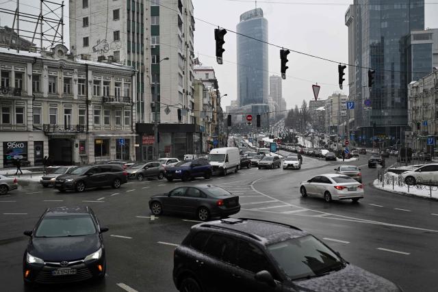 Cars drive through a crossroads with non-functioning traffic lights during a power outage in Kyiv on January 27, 2026, amid the Russian invasion of Ukraine. (Photo by Sergei GAPON / AFP)
