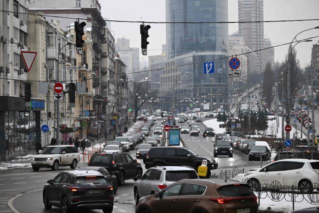 Cars drive through a crossroads with non-functioning traffic lights during a power outage in Kyiv on January 27, 2026, amid the Russian invasion of Ukraine. (Photo by Sergei GAPON / AFP)