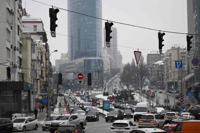 Cars drive through a crossroads with non-functioning traffic lights during a power outage in Kyiv on January 27, 2026, amid the Russian invasion of Ukraine. (Photo by Sergei GAPON / AFP)