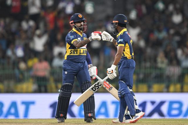 Sri Lanka's Pathum Nissanka and Kusal Mendis bump fists during the third one-day international (ODI) cricket match between Sri Lanka and England at the R. Premadasa International Cricket Stadium in Colombo on January 27, 2026. (Photo by Ishara S. KODIKARA / AFP)