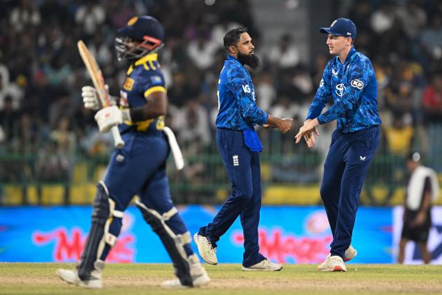 England's Adil Rashid (C) celebrates with captain Harry Brook (R) after taking the wicket of Sri Lanka's captain Charith Asalanka (L) during the third one-day international (ODI) cricket match between Sri Lanka and England at the R. Premadasa International Cricket Stadium in Colombo on January 27, 2026. (Photo by Ishara S. KODIKARA / AFP)