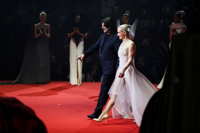 French fashion designer Stephane Rolland (rear L) acknowledges the audience at the end of the Stephane Rolland Women's Haute Couture Spring/Summer 2026 collection fashion show as part of the Paris Haute Couture Fashion Week, in Paris, on January 27, 2026. (Photo by GEOFFROY VAN DER HASSELT / AFP)