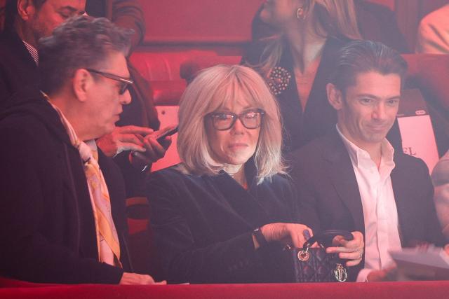 Wife of French President Brigitte Macron (C) speaks with French singer Marc Lavoine (L) as they attend Stephane Rolland Women's Haute Couture Spring/Summer 2026 collection fashion show as part of the Paris Haute Couture Fashion Week, in Paris, on January 27, 2026. (Photo by GEOFFROY VAN DER HASSELT / AFP)