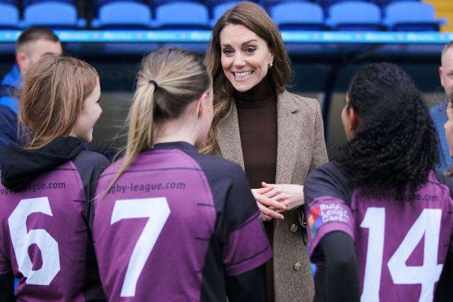 Britain's Catherine (C), Princess of Wales, meets players during a visit to Wakefield Trinity Rugby League club in Wakefield, northern England on January 27, 2026, to learn how their outreach programmes bring generations together and support individuals experiencing isolation in the community. (Photo by Ian Hodgson / POOL / AFP)
