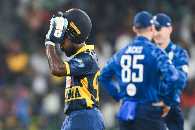 Sri Lanka's Janith Liyanage (L) walks back to the pavilion after his dismissal during the third one-day international (ODI) cricket match between Sri Lanka and England at the R. Premadasa International Cricket Stadium in Colombo on January 27, 2026. (Photo by Ishara S. KODIKARA / AFP)