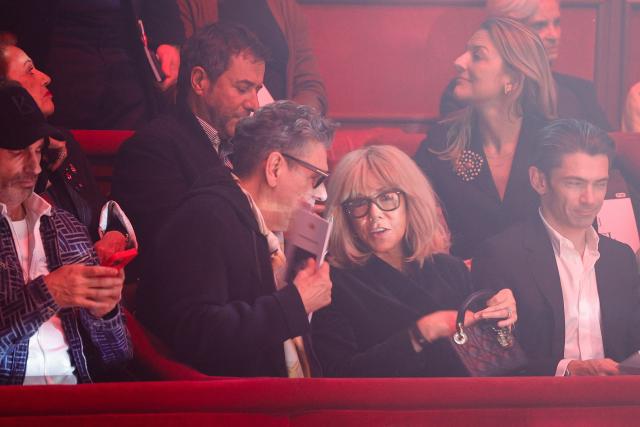 Wife of French President Brigitte Macron (C) speaks with French singer Marc Lavoine (L) as they attend Stephane Rolland Women's Haute Couture Spring/Summer 2026 collection fashion show as part of the Paris Haute Couture Fashion Week, in Paris, on January 27, 2026. (Photo by GEOFFROY VAN DER HASSELT / AFP)