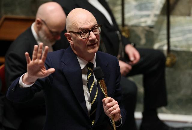 France's Economy and Finance Minister Roland Lescure delivers a speech during a session of questions to the government at The National Assembly, France's lower house parliament, in Paris on January 27, 2026. On January 27, 2026, the Assembly is expected to reject two new motions of no confidence tabled by the left outside the PS and the far right, in response to the Prime Minister's decision to once again use Article 49.3 to push through the expenditure section and the entire state budget for 2026. (Photo by Dimitar DILKOFF / AFP)