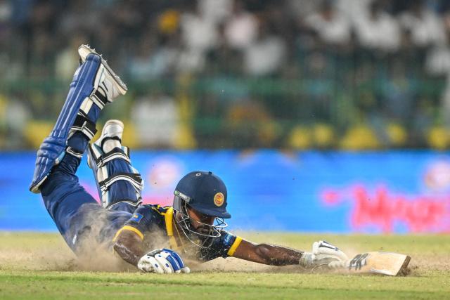 Sri Lanka's Pavan Rathnayake dives to reach the crease during the third one-day international (ODI) cricket match between Sri Lanka and England at the R. Premadasa International Cricket Stadium in Colombo on January 27, 2026. (Photo by Ishara S. KODIKARA / AFP)
