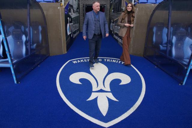 Britain's Catherine (R), Princess of Wales, meets with Marc Lovering (L), RFL's director of performance and development, during a visit to Wakefield Trinity Rugby League club in Wakefield, northern England on January 27, 2026, to learn how their outreach programmes bring generations together and support individuals experiencing isolation in the community. (Photo by Ian Hodgson / POOL / AFP)