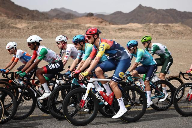 Lidl-Trek cycling team's Italian rider Jonathan Milan (C) rides in the pack during the first stage of the AlUla Tour cycling race, a 158 km race started and finished in the Saudi desert city of AlUla, on January 27, 2026. (Photo by Anne-Christine POUJOULAT / AFP)