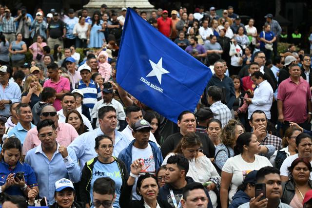 Supporters of the newly inaugurated Honduras' President Nasry Asfura gather at the Parque Central, in Tegucigalpa on January 27, 2026, following the inauguration ceremony. Asfura, a conservative businessman elected with the support of US President Donald Trump, took office as president of Honduras with an agenda linked to the United States to address the economic and security challenges facing the most impoverished and violent country in Central America. (Photo by JOHAN ORDONEZ / AFP)