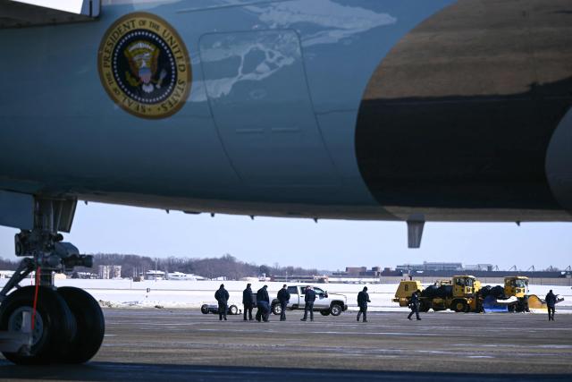 Workers clear snow before US President Donald Trump arrives to board Air Force One at Joint Base Andrews, Maryland on January 27, 2026. President Trump is on his way to Clive, Iowa to deliver a speech on the economy and energy. (Photo by Brendan SMIALOWSKI / AFP)