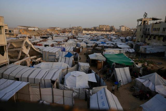 A general view of tents that houses Palestinians situated next to destroyed buildings by the Israeli military in Khan Yunis in the southern Gaza Strip on January 27, 2026. Since October 10, a fragile US-sponsored truce in Gaza has largely halted the fighting between Israeli forces and Hamas, but both sides have alleged frequent violations. (Photo by Bashar Taleb / AFP)