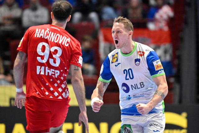 Slovenia's wing #20 Tilen Kodrin (R) celebrates scoring during the men's EHF Euro 2026 main round handball match Slovenia v Croatia in Malmoe, Sweden, on January 27, 2026. (Photo by Johan Nilsson/TT / TT NEWS AGENCY / AFP) / Sweden OUT