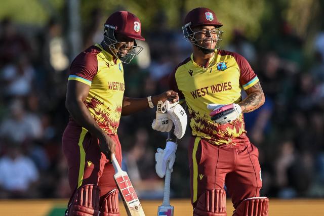 West Indies' Rovman Powell (L) and West Indies' Shimron Hetmyer (R) talk between overs during the first Twenty20 international cricket match between South Africa and West Indies at Boland Park in Paarl on January 27, 2026. (Photo by RODGER BOSCH / AFP)