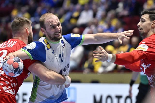 Slovenia's centre back #14 Domen Tajnik (C) vies for the ball during the men's EHF Euro 2026 main round handball match Slovenia v Croatia in Malmoe, Sweden, on January 27, 2026. (Photo by Johan Nilsson/TT / TT NEWS AGENCY / AFP) / Sweden OUT