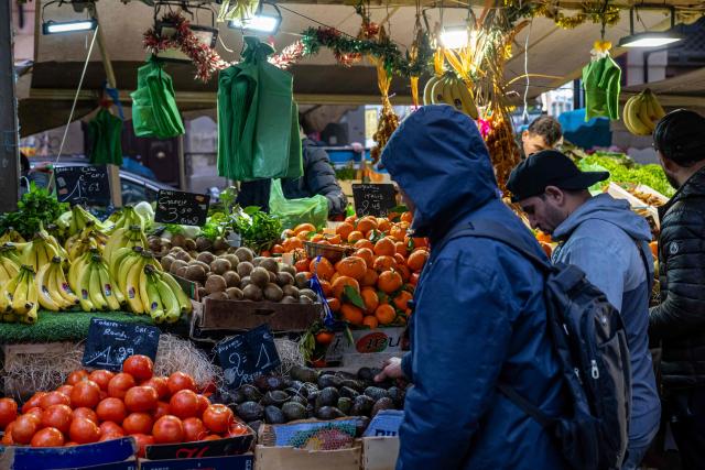 Customers buy products at the Capucins (or Noailles) food market in central Marseille, southern France on January 27, 2026. (Photo by Miguel MEDINA / AFP)