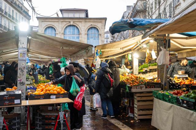 Customers buy products at the Capucins (or Noailles) food market in central Marseille, southern France on January 27, 2026. (Photo by Miguel MEDINA / AFP)