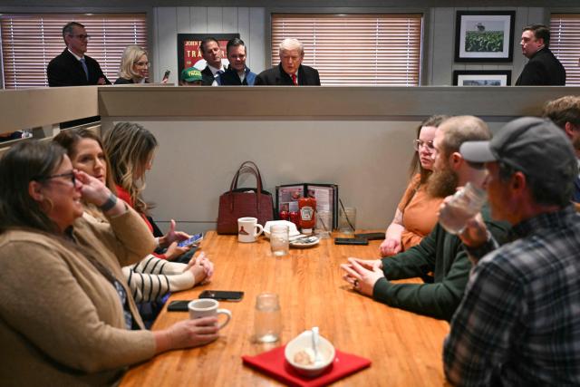US President Donald Trump greets patrons during a stop at the Machine Shed restaurant in Urbandale, Iowa, on January 27, 2026. (Photo by Brendan SMIALOWSKI / AFP)