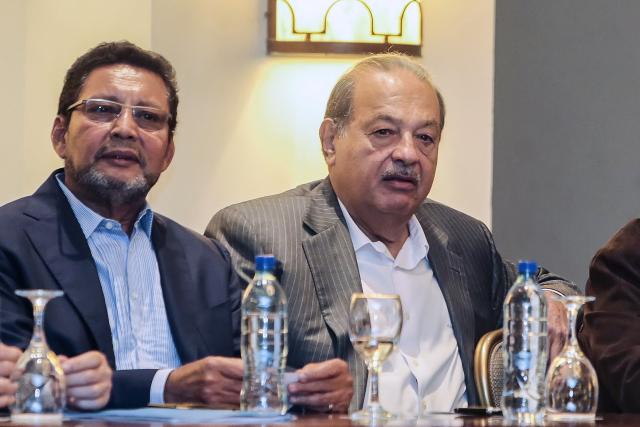 (FILES) Mexican tycoon Carlos Slim (R), and the Economy Adviser to the Presidency Bayardo Arce, are pictured during a meeting with Nicaraguan businessmen in Managua on September 10, 2015. The Nicaraguan justice system convicted historic Sandinista commander Bayardo Arce, former economic adviser to President Daniel Ortega, of corruption and confiscated his assets, the Nicaraguan government reported on January 27, 2026, without specifying the sentence. (Photo by Inti Ocon / AFP)