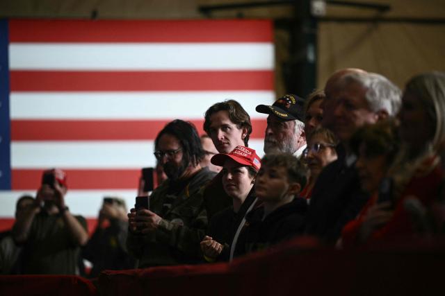 Attendees listen to US President Donald Trump deliver remarks on the economy in Clive, Iowa, on January 27, 2026. (Photo by Brendan SMIALOWSKI / AFP)