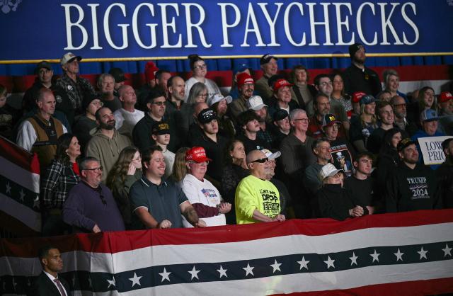 Attendees listen to US President Donald Trump deliver remarks on the economy in Clive, Iowa, on January 27, 2026. (Photo by Brendan SMIALOWSKI / AFP)