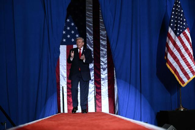 US President Donald Trump arrives to deliver remarks on the economy in Clive, Iowa, on January 27, 2026. (Photo by Brendan SMIALOWSKI / AFP)