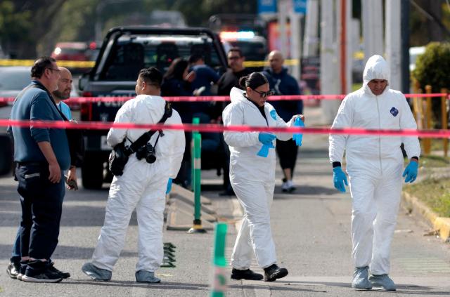Forensic personnel prepare to work at the scene where a hotel owner was attacked, an incident that left one assailant dead in a hospital and five people wounded by gunfire in a commercial area of Zapopan, Jalisco, Mexico on January 27, 2026 (Photo by ULISES RUIZ / AFP)
