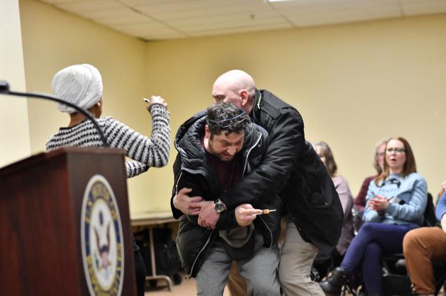 A man is tackled after spraying an unknown substance at US Representative Ilhan Omar (D-MN) (L) during a town hall she was hosting in Minneapolis, Minnesota, on January 27, 2026. (Photo by Octavio JONES / AFP)