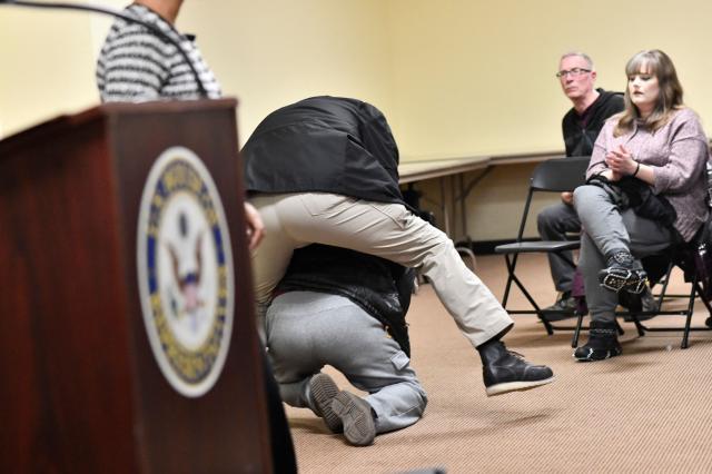 A man is tackled after spraying an unknown substance at US Representative Ilhan Omar (D-MN) (L) during a town hall she was hosting in Minneapolis, Minnesota, on January 27, 2026. (Photo by Octavio JONES / AFP)