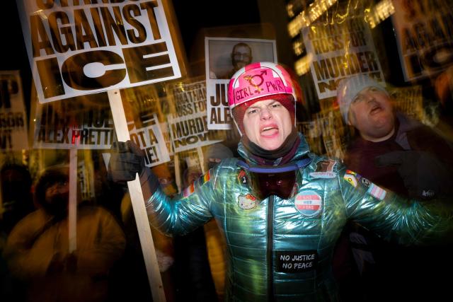 A group of anti-US Immigration and Customs Enforcement (ICE) protesters hold signs and shout slogans in downtown Minneapolis, Minnesota, on January 27, 2026. US President Donald Trump said on January 27 that he would "de-escalate a little bit" in Minneapolis after the fatal shootings of two civilians fueled a storm of criticism over his signature immigration crackdown. (Photo by ROBERTO SCHMIDT / AFP)