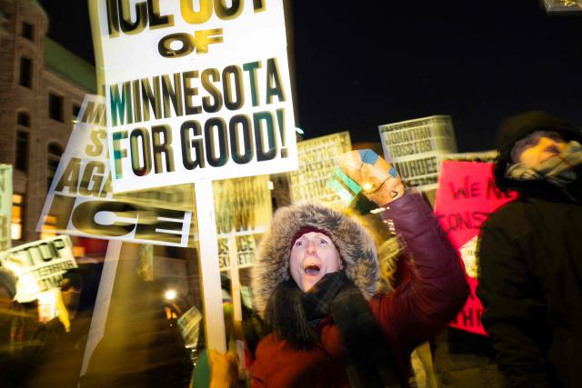 A group of anti-US Immigration and Customs Enforcement (ICE) protesters hold signs and shout slogans in downtown Minneapolis, Minnesota, on January 27, 2026. US President Donald Trump said on January 27 that he would "de-escalate a little bit" in Minneapolis after the fatal shootings of two civilians fueled a storm of criticism over his signature immigration crackdown. (Photo by ROBERTO SCHMIDT / AFP)