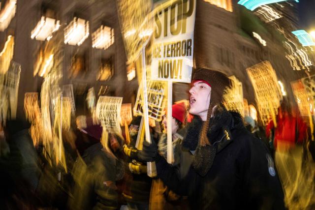 A group of anti-US Immigration and Customs Enforcement (ICE) protesters shout slogans in downtown Minneapolis, Minnesota, on January 27, 2026. US President Donald Trump said on January 27 that he would "de-escalate a little bit" in Minneapolis after the fatal shootings of two civilians fueled a storm of criticism over his signature immigration crackdown. (Photo by ROBERTO SCHMIDT / AFP)