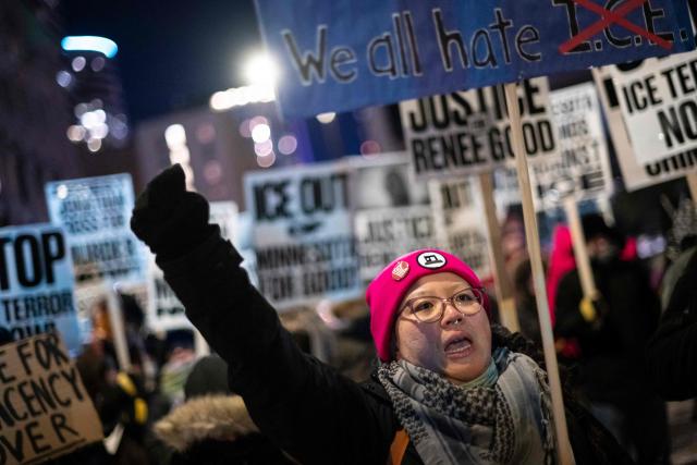A group of anti-US Immigration and Customs Enforcement (ICE) protesters hold signs and shout slogans in downtown Minneapolis, Minnesota, on January 27, 2026. US President Donald Trump said on January 27 that he would "de-escalate a little bit" in Minneapolis after the fatal shootings of two civilians fueled a storm of criticism over his signature immigration crackdown. (Photo by ROBERTO SCHMIDT / AFP)
