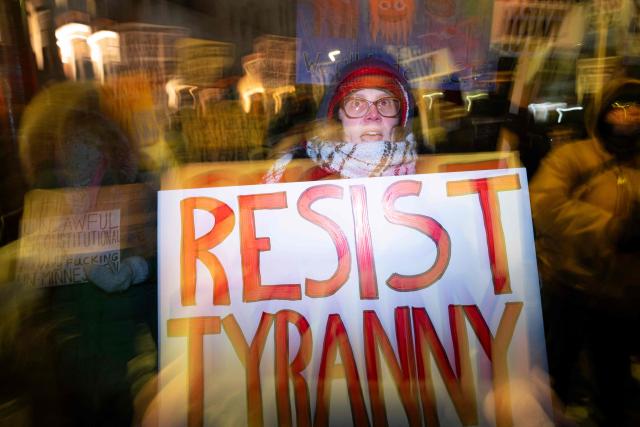 A group of anti-US Immigration and Customs Enforcement (ICE) protesters hold signs and shout slogans in downtown Minneapolis, Minnesota, on January 27, 2026. US President Donald Trump said on January 27 that he would "de-escalate a little bit" in Minneapolis after the fatal shootings of two civilians fueled a storm of criticism over his signature immigration crackdown. (Photo by ROBERTO SCHMIDT / AFP)