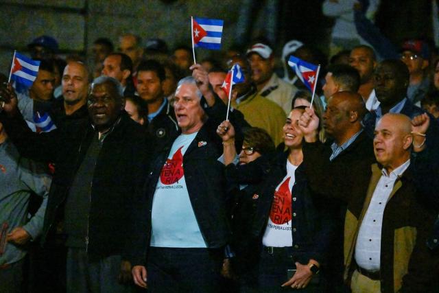 Cuba's President Miguel Diaz-Canel (C-L) takes part in the Torchlight March on the 173rd anniversary of National Hero Jose Marti (a leader of Cuba’s independence from Spain and founder of the Cuban Revolutionary Party) in Havana on January 27, 2026. (Photo by ADALBERTO ROQUE / AFP)