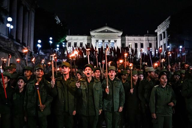 TOPSHOT - Cuban soldiers take part in the Torchlight March on the 173rd anniversary of National Hero Jose Marti (a leader of Cuba’s independence from Spain and founder of the Cuban Revolutionary Party) in Havana on January 27, 2026. (Photo by ADALBERTO ROQUE / AFP)