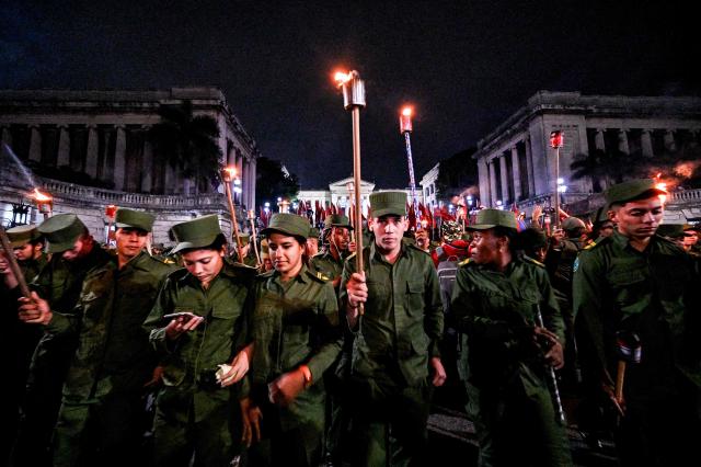 TOPSHOT - Cuban soldiers take part in the Torchlight March on the 173rd anniversary of National Hero Jose Marti (a leader of Cuba’s independence from Spain and founder of the Cuban Revolutionary Party) in Havana on January 27, 2026. (Photo by ADALBERTO ROQUE / AFP)
